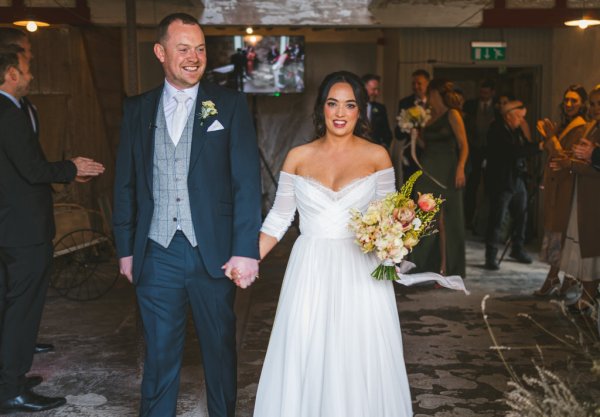 bride and groom are all smiles as they exit ceremony