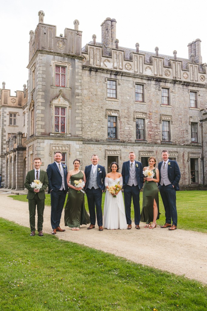 bride groom bridesmaids and groomsmen outside the pathway to wedding venue