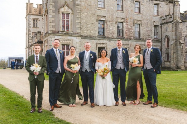 bride groom bridesmaids and groomsmen outside the pathway to wedding venue