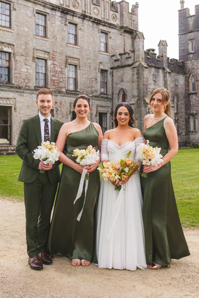 bride in the middle and bridesmaids on either side and brother