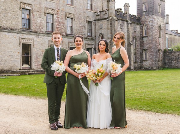 bride in the middle and bridesmaids on either side and brother