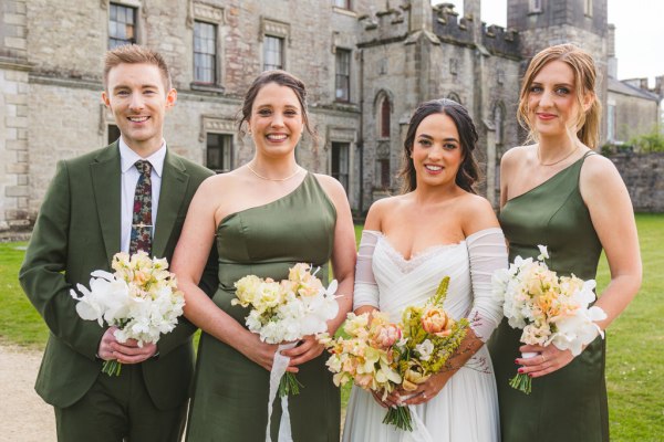 bride in the middle and bridesmaids on either side and brother