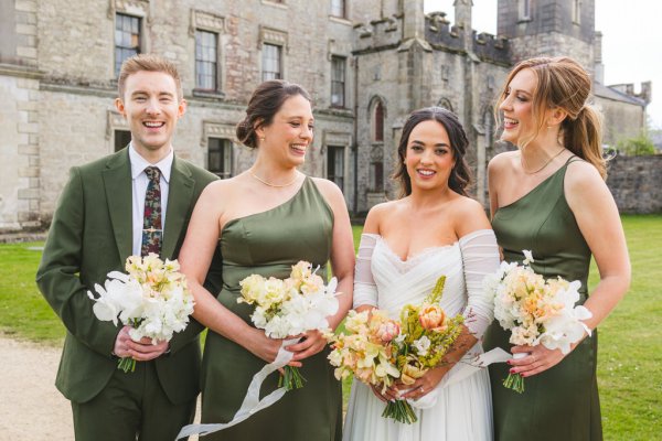 bride in the middle and bridesmaids on either side and brother