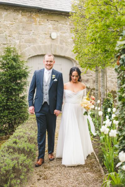 bride and groom in garden they begin to walk