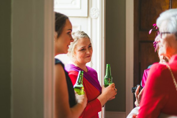 guests chatting and drinking bottles of beer