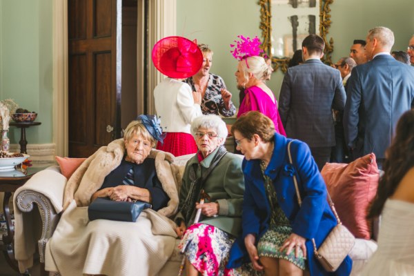 elderly women sit and chat on sofa couch