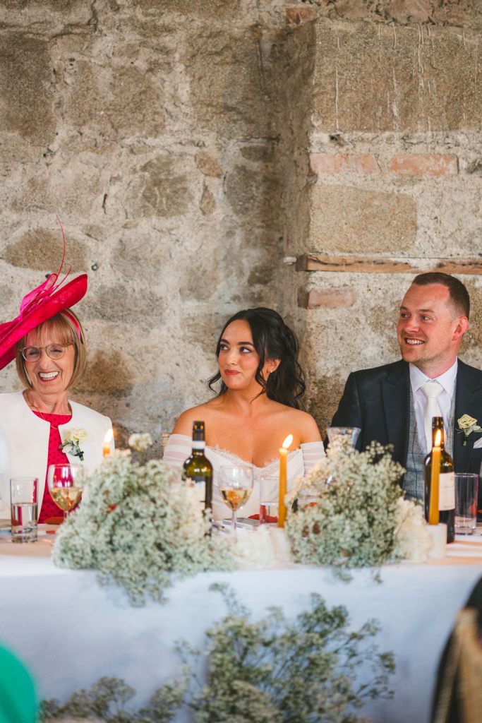 mother father and daughter bride at table