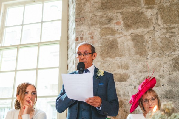 father reads out speech to audience