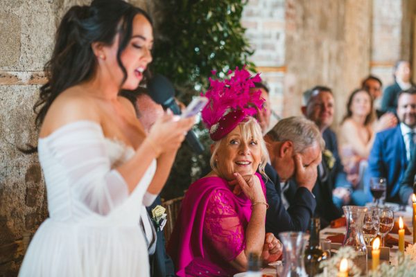 bride gives speech at dining room table