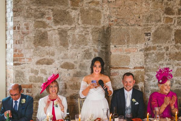 bride in the middle of mother and father gives speech