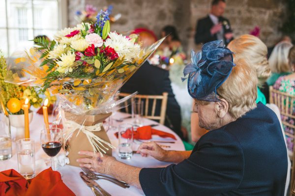 table guests laughing during speeches