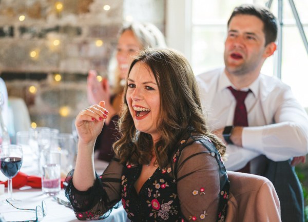 woman laughs in audience