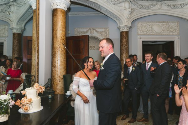 bride and groom about to cut the wedding cake