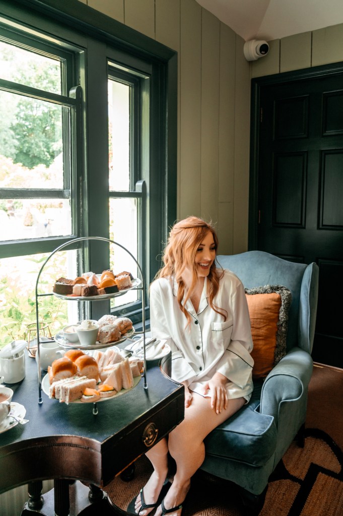 bride enjoys afternoon/high tea at table setting beside window