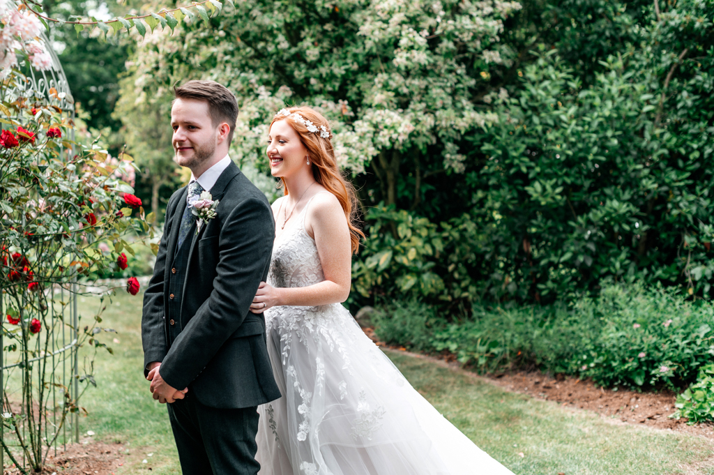 bride and groom in garden setting smiling