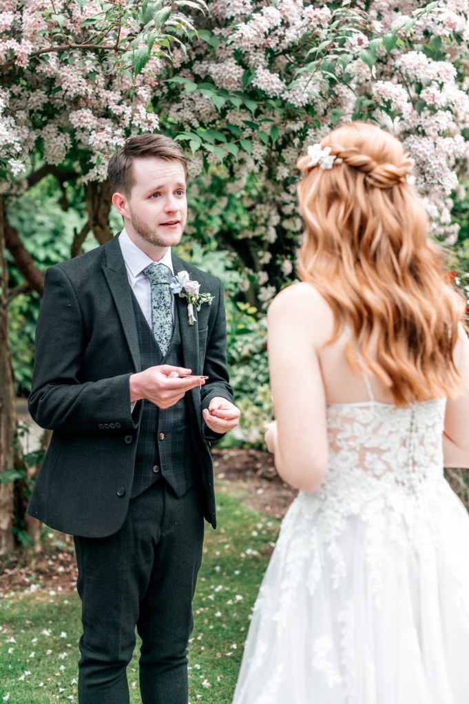 bride and groom chat to each other in garden