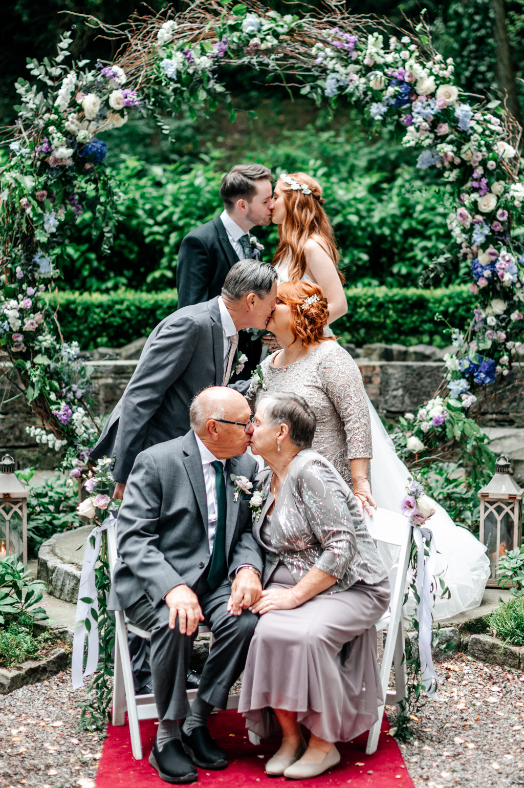 mother and father kissing guests bride and groom kiss