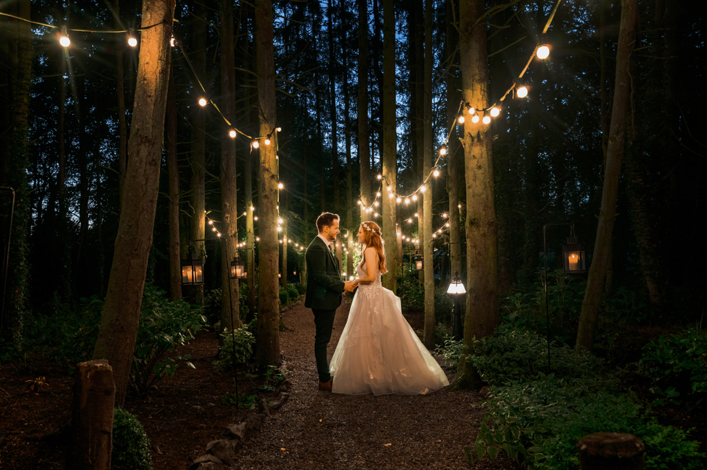 Couple dance at nighttime surrounded by lights