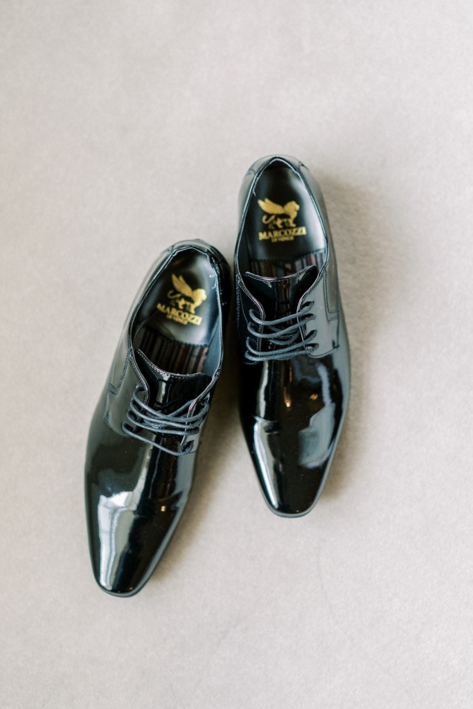 Black patent brogues on a cream carpet