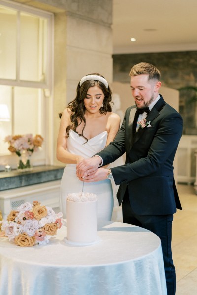 Bride and groom cutting their wedding cake