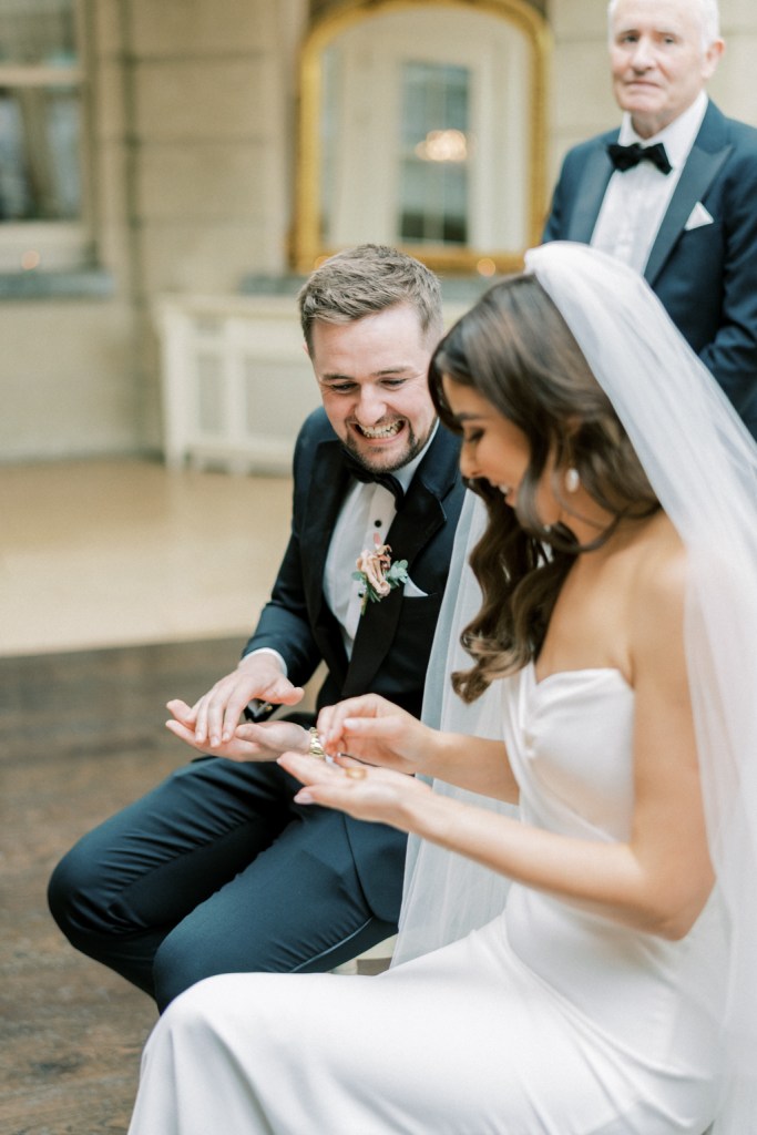 Bride and groom sit at the top of an aisle