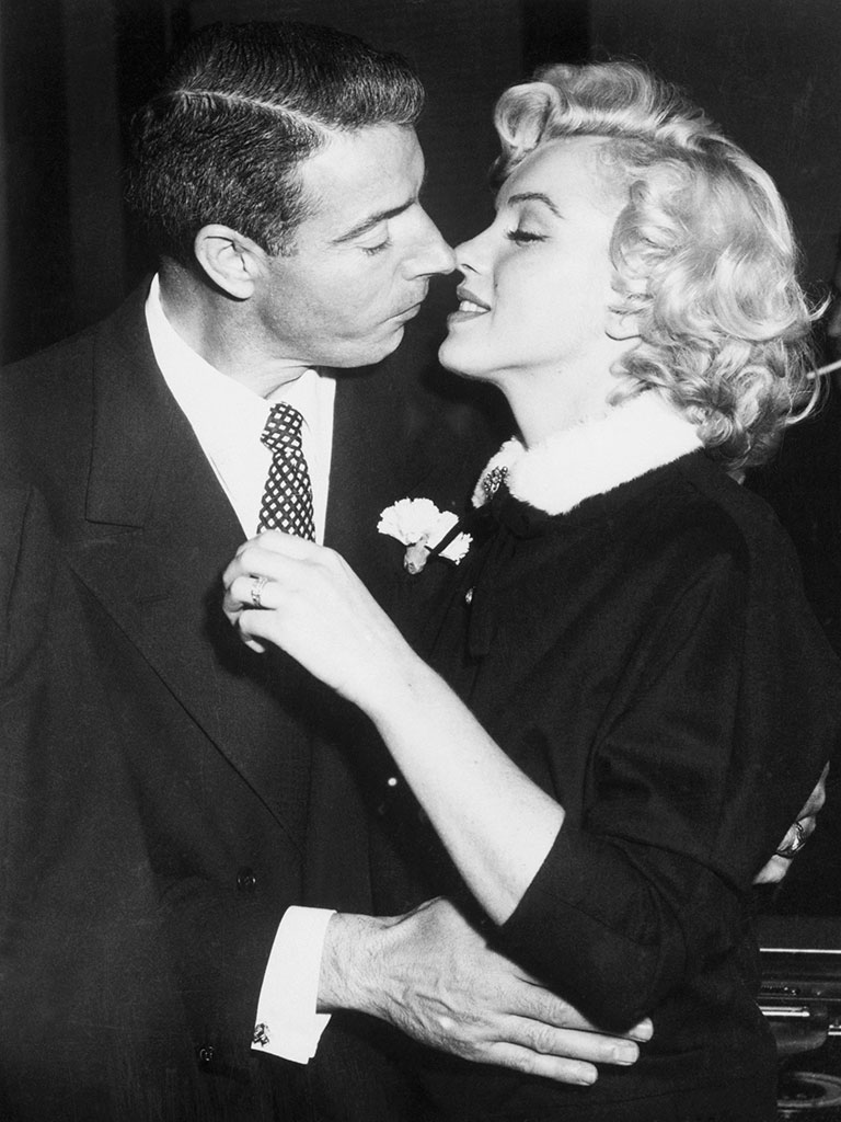 Joe DiMaggio and Marilyn Monroe kiss following their marriage ceremony in a judge's chambers in San Francisco, California.