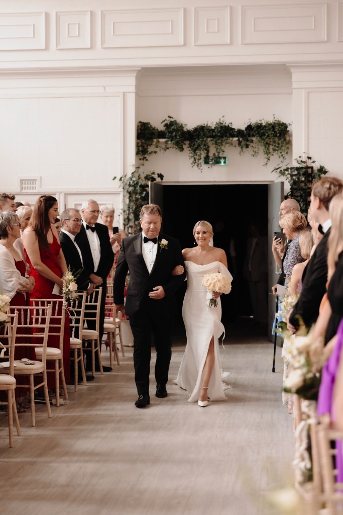 father of the bride walks her down the aisle