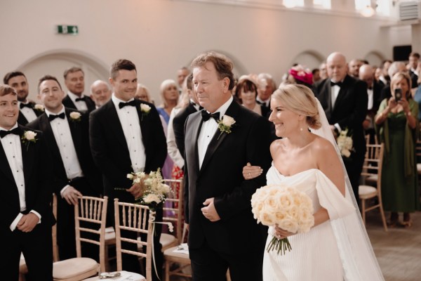 father of the bride walks her down the aisle