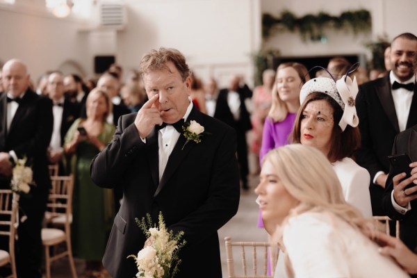 emotional father hands his daughter bride over to groom at alter