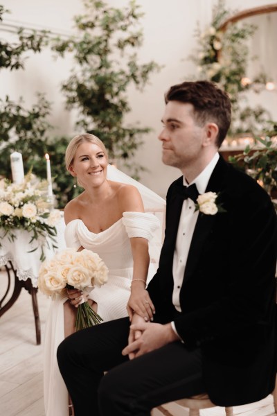 bride smiles at groom during ceremony