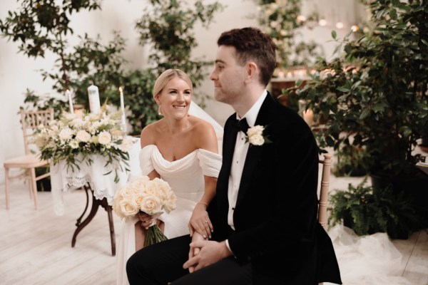 bride smiles at groom during ceremony