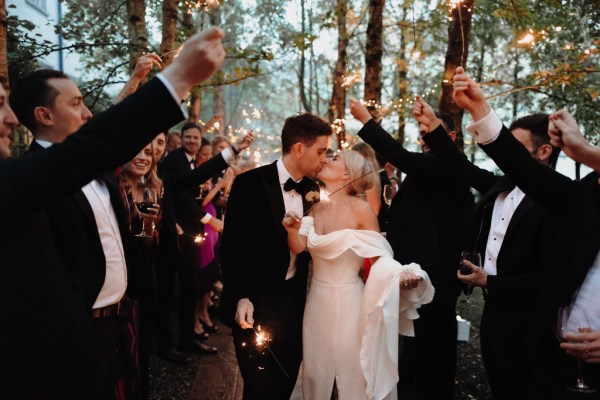 bride and groom kissing exit ceremony confetti over couple