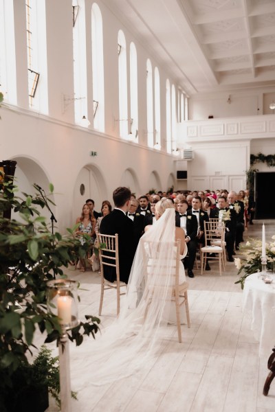 bride and groom sitting at alter facing audience