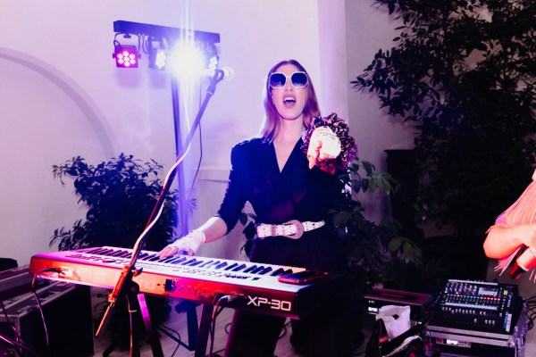 female DJ playing music wearing sunglasses