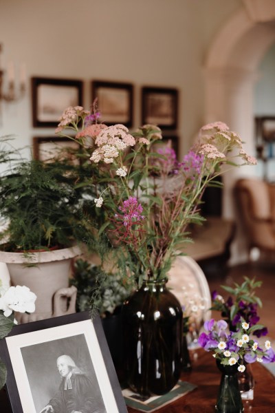 portraits on table of family and flowers