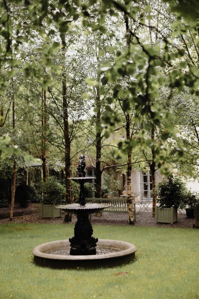 fountain in garden green grass