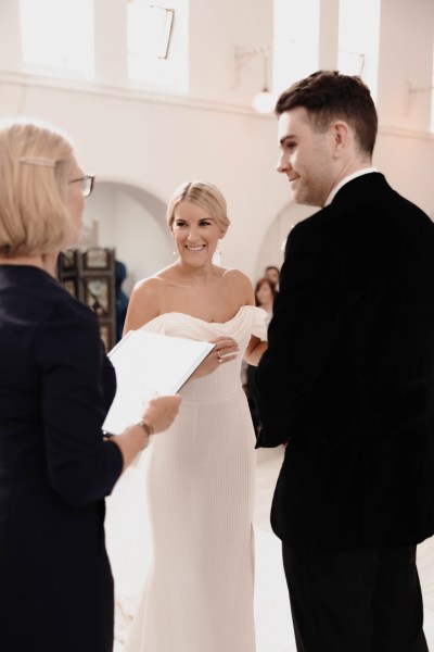 bride and groom at the alter together with celebrant reading sermon