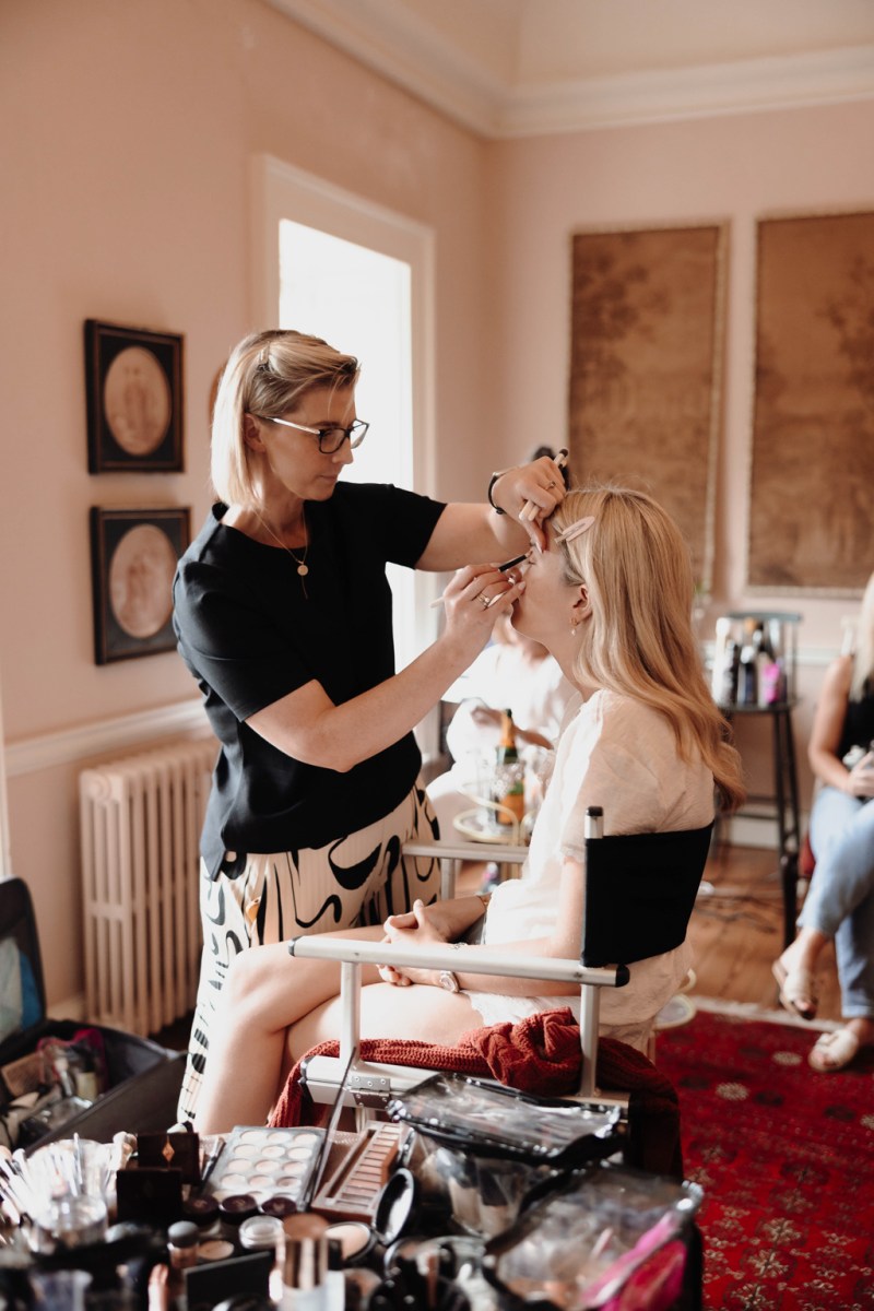 makeup artist doing brides makeup