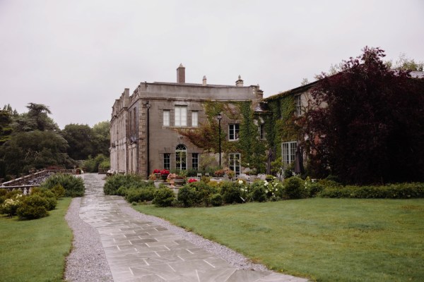 extrerior wedding venue pathway garden flowers grass