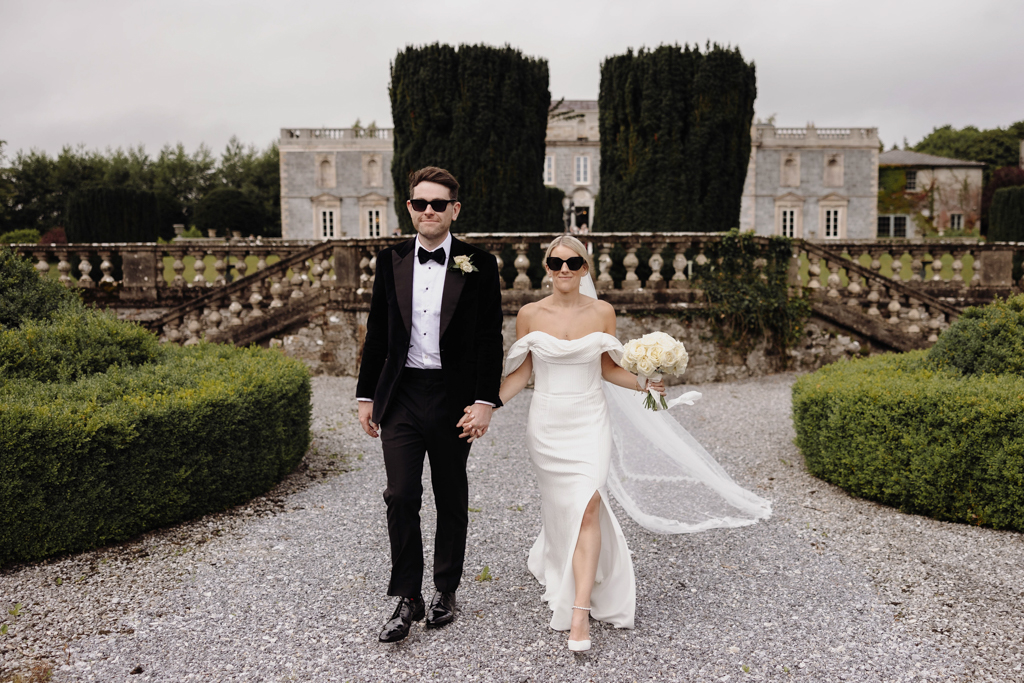 bride and groom standing in courtyard to wedding venue