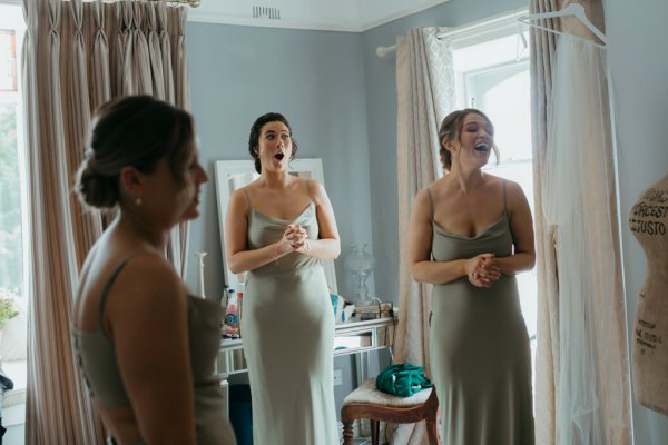 bridesmaids in room waiting for bride getting ready