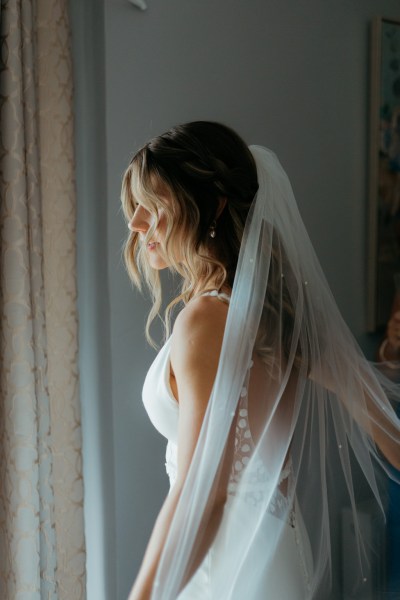 bride smiles wearing veil