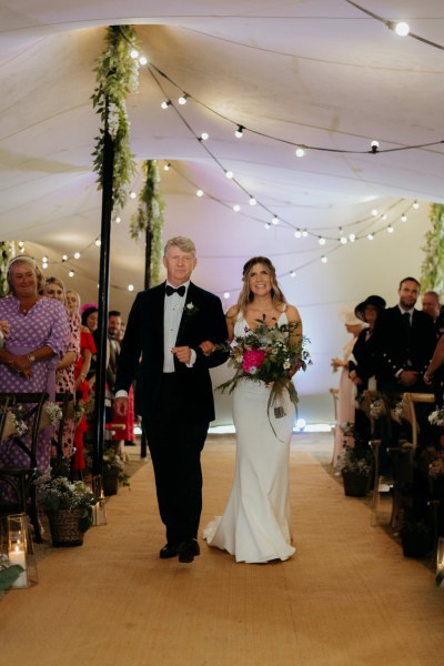 father of the bride walks his daughter down the aisle