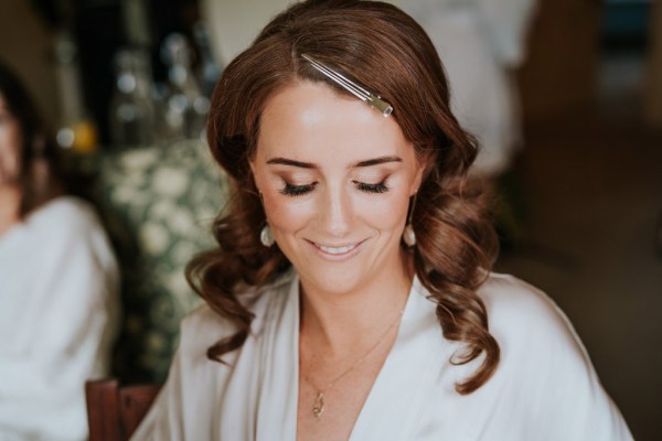 bridesmaid looks down as she gets ready hair and makeup