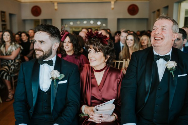 groom and his mother and father seated together