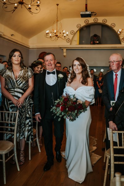 father of the bride walks his daughter down the aisle