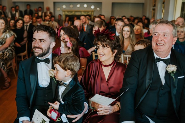 audience members groom little boy mother father and guests