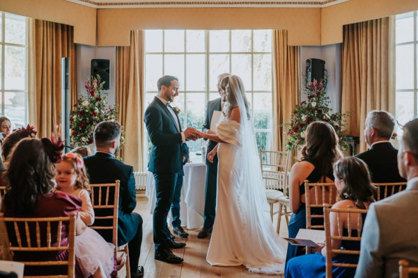 bride and groom stand at top of alter with celebrant