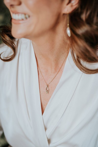 close up of brides necklace and earrings as she gets ready