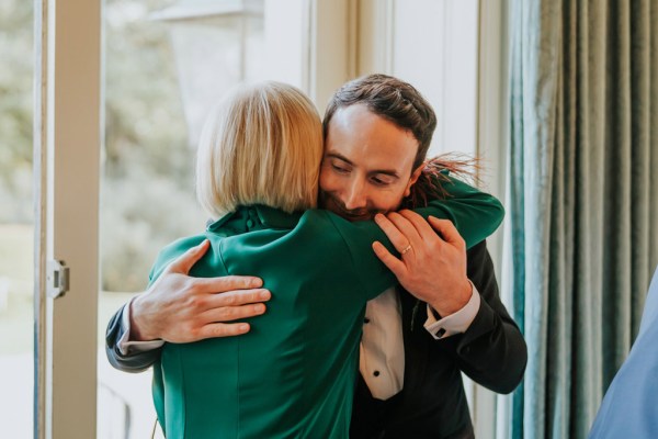 groom hugs mum mother